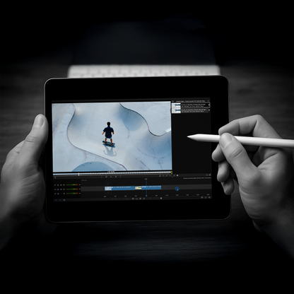 Person holding a stylus over a tablet displaying a video editing interface.